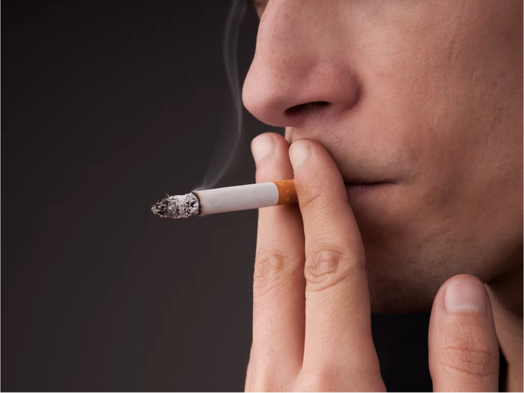 Photo of men smoking affecting facial features