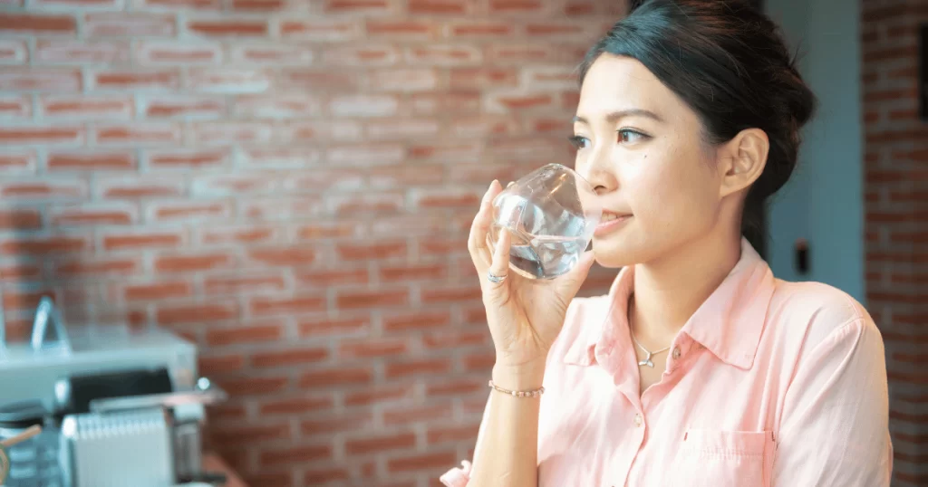 Asian woman drinking water Singapore